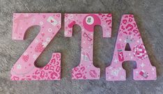 the letters are made out of wood and decorated with animal prints, such as pink