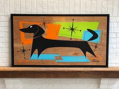 a dog is standing on a shelf in front of a brick wall with an abstract painting