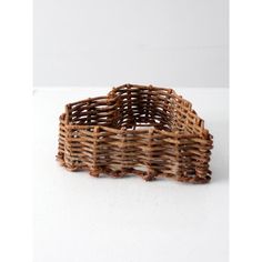 a wicker basket sitting on top of a white table