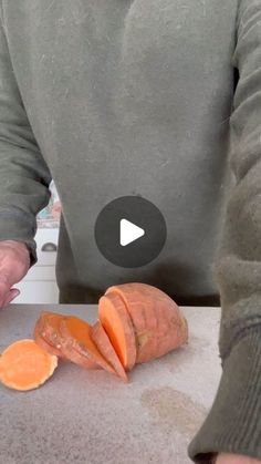 a person cutting up carrots on top of a counter