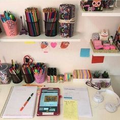 the desk is full of pens, pencils, and other office supplies on it