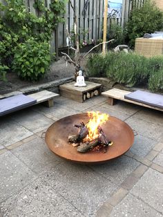 a fire pit sitting on top of a stone patio