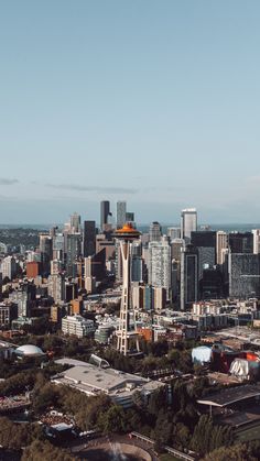 an aerial view of a city with tall buildings and a water tower in the distance