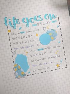 an open notebook with writing on it and a pen in front of the page that says life goes on