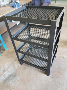 a metal shelf with mesh sides in a shop