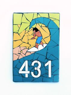 a mosaic tile depicting a surfer riding a wave with the number thirteen4 on it