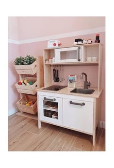 a kitchen with a microwave, sink and shelves