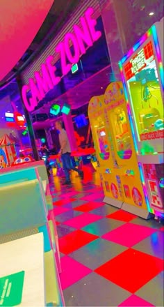 the inside of a game zone with arcade machines and neon colors on the floor,