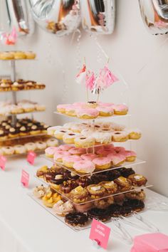 a table topped with lots of donuts covered in frosting