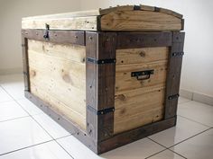 a large wooden chest sitting on top of a tiled floor