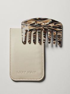 The travel-size mini Mocha Marble Detangling Comb is perfect for smoothing flyaways on the fly (espresso drink not included). Crafted from marbled cellulose acetate, which creates less static than other materials. This wide-tooth comb is crafted for gentle detangling and comes with a cream-colored vegan bio-based leather storage case. All sales final. faq what-is-the-mini-detangling-comb what-are-the-dimensions-of-the-mini-detangling-comb can-i-return-or-exchange-the-en-suite-spa-kit Espresso Drink, Detangling Comb, Holiday Wishlist, Luxy Hair, Straight Hair Cuts, Leather Storage, Espresso Drinks, Wide Tooth Comb, Cellulose Acetate