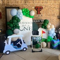 balloons are set up in the shape of golf carts and cars for a birthday party