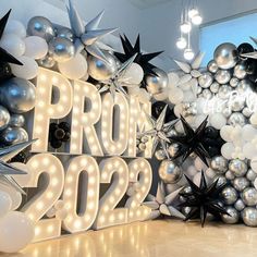 balloons and lights decorate the entrance to a new year's eve party