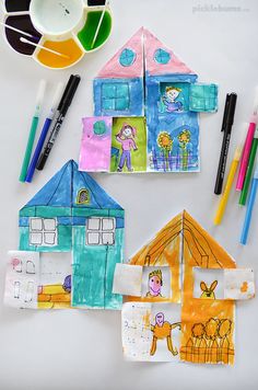 children's art project with paper houses and crayons