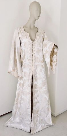 For Sale on 1stdibs - Elegant Moroccan white ivory and old brocade kaftan embroidered with gold trim threads. Size L to XL circa 1980s. This long maxi dress kaftan is embroidered Middle Eastern Outfits Women, Silk Kaftan With Floral Embroidery For Wedding, Festive Cream Kaftan With Resham Embroidery, Embroidered Silk Maxi Length Kaftan, Festive White Kaftan With Resham Embroidery, Cream Kaftan With Resham Embroidery For Festive Occasions, Cream Resham Embroidery Kaftan For Festive Occasions, White Silk Kaftan For Festive Occasions, Silk Tunic Kaftan For Wedding