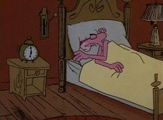 a cartoon character laying in bed with an alarm clock on the nightstand next to him