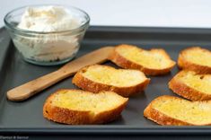 slices of bread on a baking tray with butter