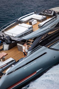 two people standing on the deck of a boat