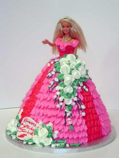 a barbie doll cake with flowers on it