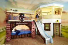 a kid's bedroom with a slide and bunk beds