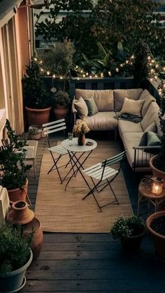 an outdoor living area with potted plants and lights on the roof top, along with patio furniture