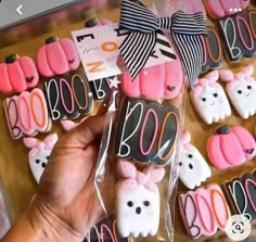 someone is holding up some decorated cookies in the shape of rabbits and cats with bows