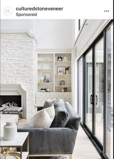 a living room filled with furniture and a fire place in front of a window next to a fireplace