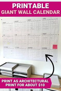 the printable giant wall calendar is on display in front of a whiteboard with pink lettering