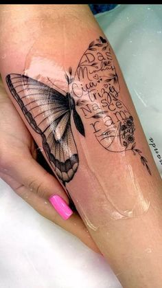 a woman's leg with a butterfly tattoo on it