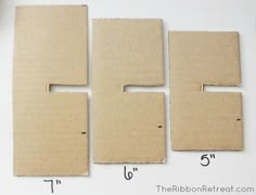 four pieces of cardboard laid out on top of each other with numbers cut into them