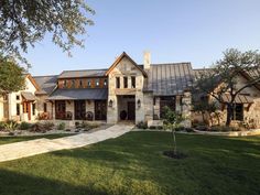 a large house with lots of windows in the front yard