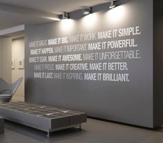 a wall with words written on it next to a bench