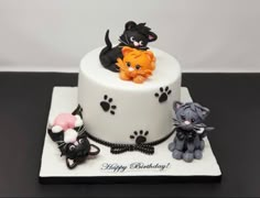 a birthday cake decorated with cats and kittens