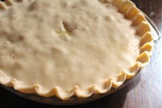 an uncooked pie sitting on top of a wooden table