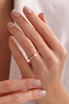 a woman's hand with a ring on it