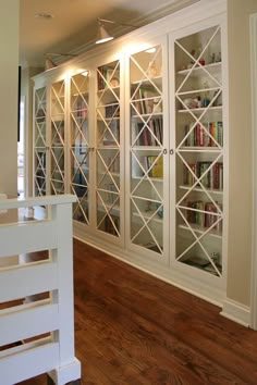 a white bookcase with glass doors on it