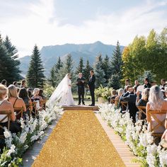 a bride and groom standing at the end of their wedding ceremony