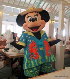 the mickey mouse mascot is dressed in his pajamas and hat