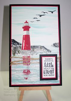 a card with a lighthouse and birds on it