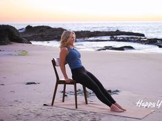 a woman sitting on top of a chair in front of the ocean while doing yoga