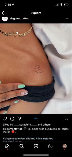 a woman's stomach with tattoos on her chest and the word love is written in cursive writing