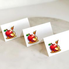 three place cards with an apple on them