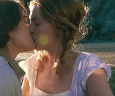 two women are kissing each other outside