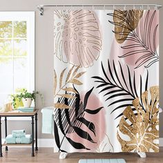 the shower curtain is decorated with gold and pink tropical leaves on white background, along with a blue rug