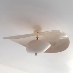 a white ceiling fan with two lights on it's sides and a light fixture in the middle