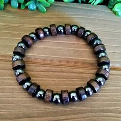 This Is A Men's Beaded Bracelet With Dark Brown "Real Wood" And Hematite Beads. The Wood Beads Are Round And Cylinder-Shaped. The Bracelet Is Made With Strong And Durable Elastic That Allows It To Easily Stretch Over Your Hand To Your Wrist. Multiple Sizes Available The Bracelet Can Be Made Any Size So Women Can Wear Too. Message Me If You Need Another Size The Diameter On The Wood Bead Is 10mm And The Hematite Is 8mm. The Bracelet Is Ready For Gift Giving Fast Shipping Adjustable Hematite Bracelets, Casual Round Beaded Hematite Bracelets, Adjustable Wooden Beaded Bracelet, Mens Stretch Bracelets, Crystal Diy, Wood Bead Bracelet, Hematite Bracelet, Diy Crystals, Cylinder Shape