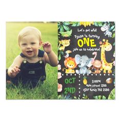 a baby is sitting in the grass with his first birthday card