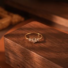 three stone ring sitting on top of a wooden box