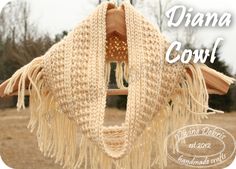 a crocheted shawl hanging from a clothes hanger with the words, diama cowl written below it