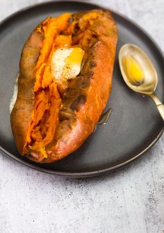 an air fryer sweet potato on a black plate